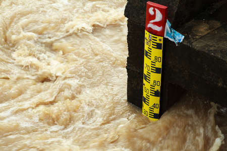 Ruler indicating the height of the water in the riverの写真素材
