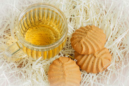 Cookies and tea cup on fiber paperの写真素材
