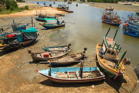 Harbor for park small fishing boats at low tideの写真素材