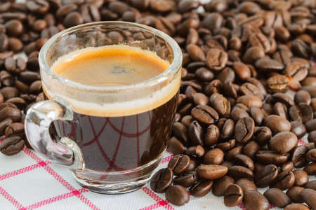 Coffee cups and coffee beans on the table.
