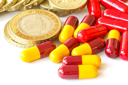 Pills and money on white background