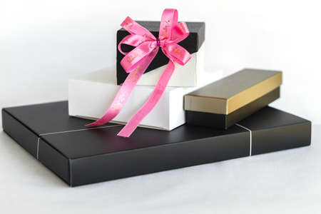 Gold black and white gift box with pink ribbon bow
