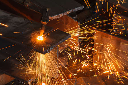 Closeup metal cutter, steel cutting with acetylene torch, industrial worker on manufacturing area.