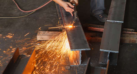 Metal cutter, steel cutting with acetylene torch, industrial worker on manufacturing area.