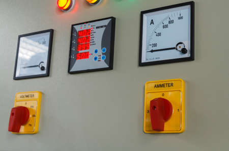 Volt and amp meter switching button on electric control panel.