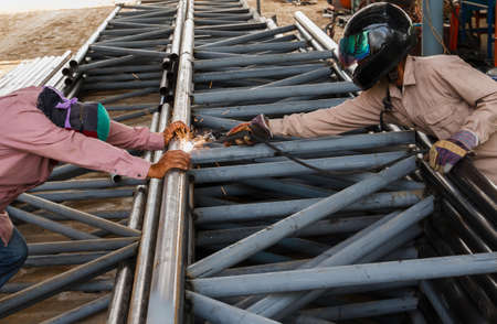 Worker without safety protective welding steel structure in construction factory, Use the wrong kind...