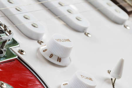 Bridge and metallic strings and tuner button of an electric guitar, Close-up picture.の写真素材