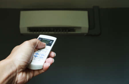 Air condition control by using remote control on gray background.の写真素材