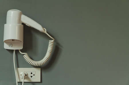 Hair dryer isolated on gray background.の写真素材
