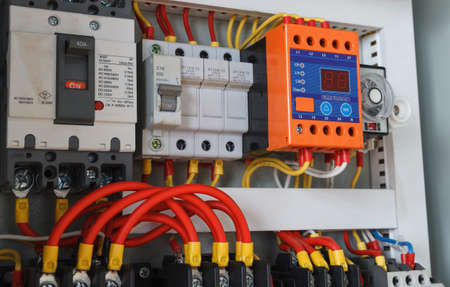 Close-up electrical wiring with fuses and contactors.