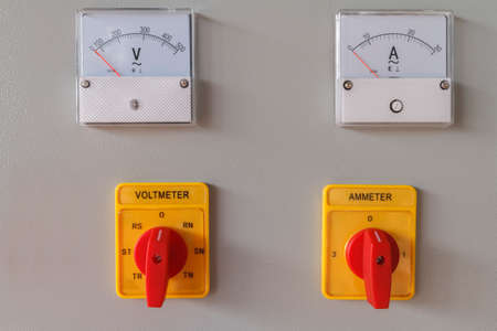 Volt and Amp meter switching button on electric control panel.の写真素材