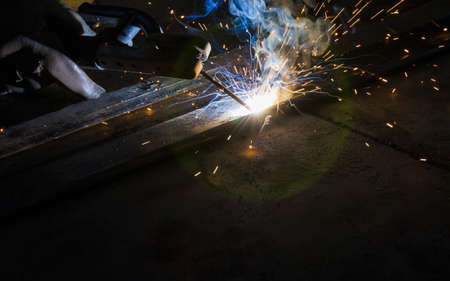 Arc welding and welding fumes at the factory welding closeup.の写真素材