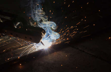 Arc welding and welding fumes at the factory welding closeup.の写真素材