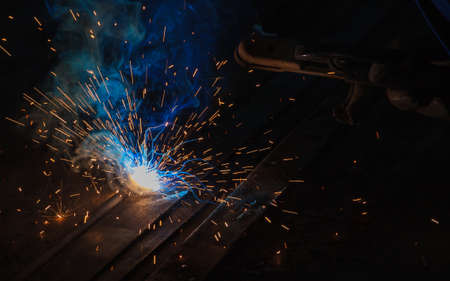 Arc welding and welding fumes at the factory welding closeup.の写真素材