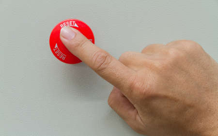 Finger touch on red emergency stop switch button.の写真素材