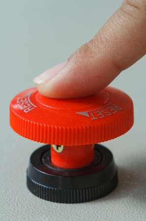 Finger touch on red emergency stop switch button.の写真素材