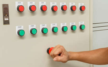 Fist smash touch on red emergency stop switch and reset with green start buttons.