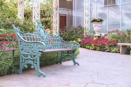 A green colour bench in a garden.の写真素材