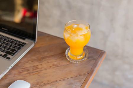 Orange juice and laptopの写真素材