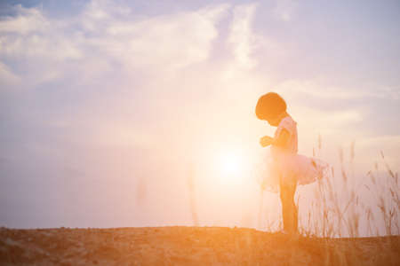 Silhouette girls playing in the gardenの写真素材