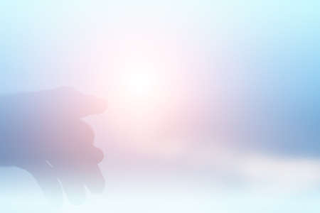 Silhouette of a hand overlooking the sunset background. Goal conceptの写真素材
