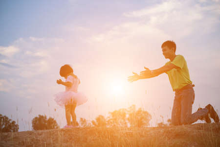 Father and his daughter playing in the gardenの写真素材