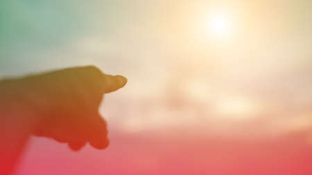 A hand with the sunset background