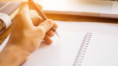A hand writing on a business record book
