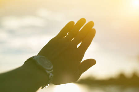 A hand with the sunset background