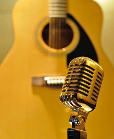 Retro golden microphone, guitar backgroundの写真素材