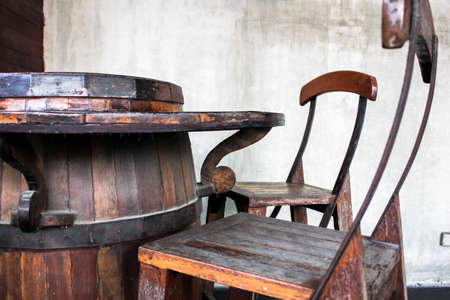 Table chairs made from wine fermentation tanks, furniture for relaxing and gardening, Southern wooden cafe coffee house restaurant vintage interior terrace. Traditional asian interior elements, Vintage effect.の写真素材