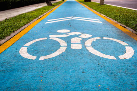 Bicycle sign on the road, Bicycle sign on bicycle way, Bicycle lanes, designed to make cycling safer, Lane road for bicycle, Bicycle sign on blue groundの写真素材
