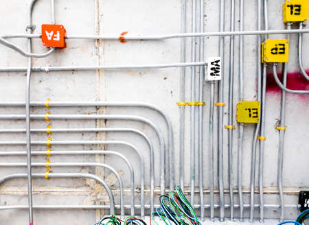 electric lines power and label on the wall ement of construction house building, pipe line constructionの写真素材