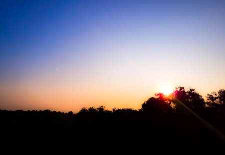 sunrise and sunset mountain view, Thunderclouds sunset on forest and lake silhouette background. Nature summer sunlight wallpaperの写真素材