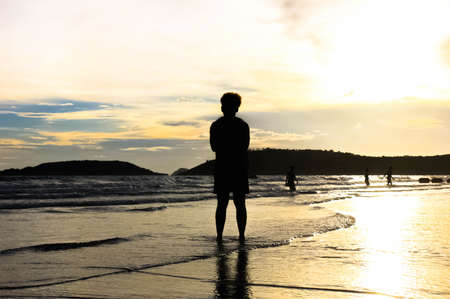 Relax on the beautiful sunset beach on Koh Chang, Thailand. Silhouette at people on the ocean beach at sunset on Koh Chang,Thailand. The beauty of the people who are enjoying the sunset on the beach, Thailand.の写真素材