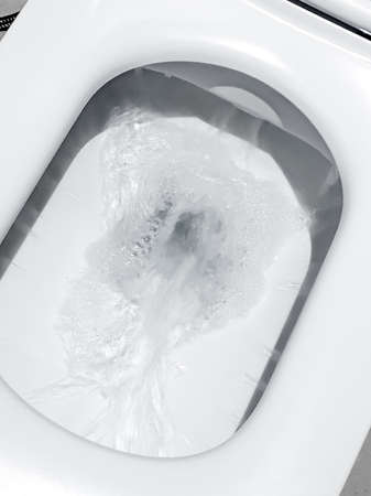 Toilet, Flushing Water, flush toilet, Closeup look at toilet, white toilet, White toilet in the bathroom, Top view of toilet bowlの写真素材