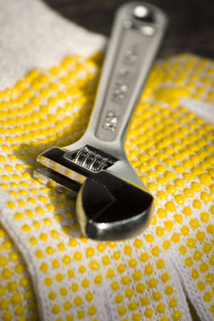 a photo of a adjustable wrench on a gloveの写真素材