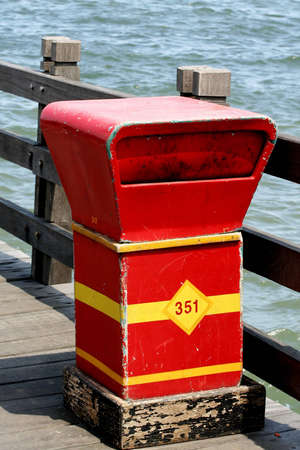 dirty trash bin on the beachの写真素材