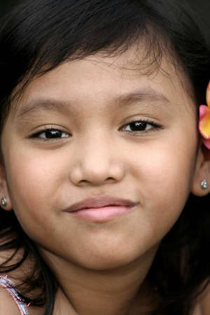 close up face of asian little girl with a sweet smileの写真素材