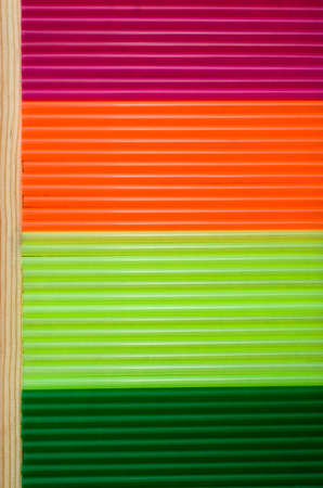 arrangement of colorful straw on a wooden board as a backgroundの写真素材