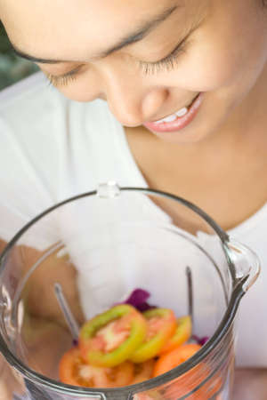 beautiful asian young woman preparing to make vegetables juice の写真素材