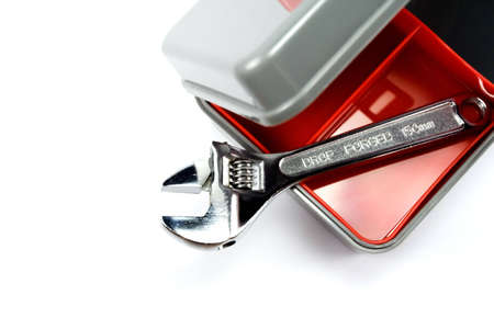 clean plastic tool box and an adjustable wrench isolated on whiteの写真素材