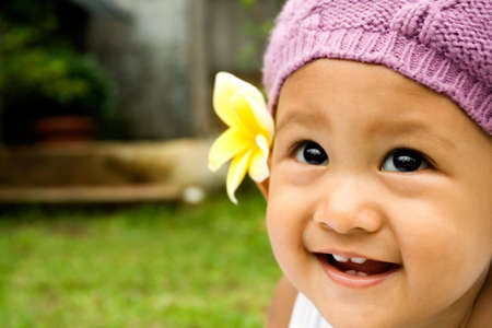 smiley face of an adorable asian baby girlの写真素材