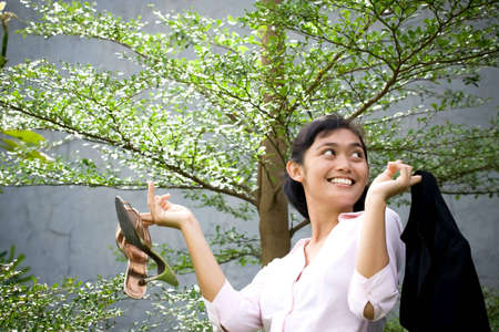 conceptual portrait of pretty asian businesswoman in nature environment, seems to enjoy her break time from busy and stressing life in the office/businessの写真素材