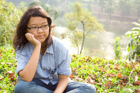 portrait of asian female teenager contemplating in nature environmentの写真素材