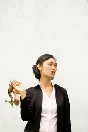 sad and jobless asian businesswoman after getting fired. standing on a white backgroundの写真素材