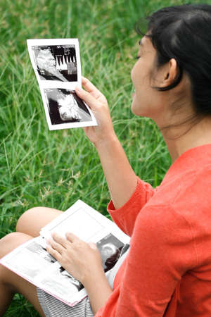 pregnant ethnic woman happy with ultrasound resultの写真素材