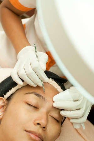 Closeup asian woman facial treatment at beauty clinicの写真素材