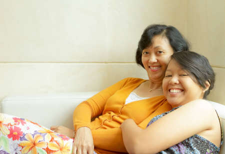 Family closeness of Asian ethnic mother together with teen daughterの写真素材
