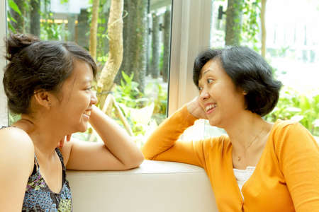 Closeness and friendship between asian ethnic mother and teen daughterの写真素材